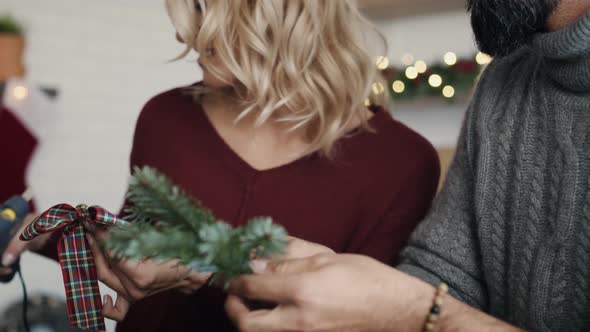 Happy couple preparing decorations for Christmas. Shot with RED helium camera in 8K