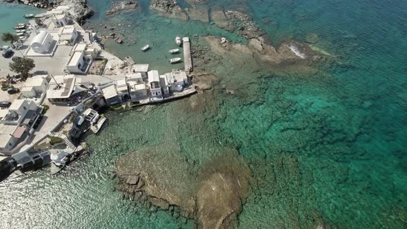 Sleepy Mediterranean town surrounded by gorgeous turquoise blue waters. Summertime Milos Greece 4k.