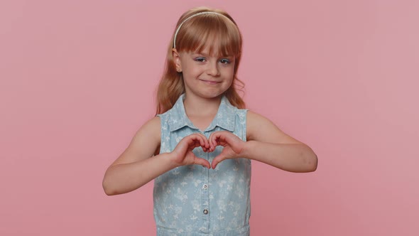 Smiling Preteen Child Girl Kid Makes Heart Gesture Demonstrates Love Sign Expresses Good Feelings