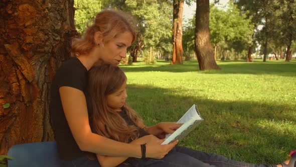 Daughter Reads the Book with Her Mother