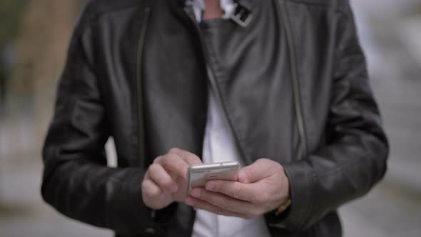 Cropped Shot of Man Using Cell Phone Outdoor