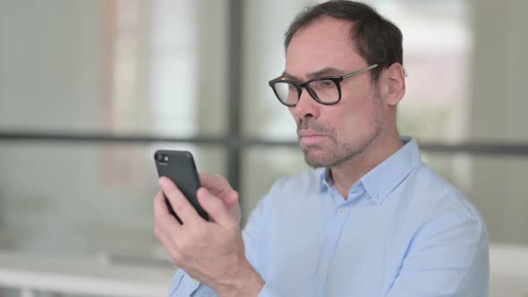 Middle Aged Man Using Smartphone