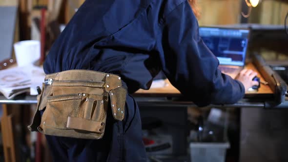 Female Craftswoman with Belt Using Laptop