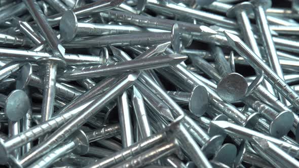 Metal Steel Nails for Construction Work Falling on a Rotating Surface Hobnails are Spinning Close Up