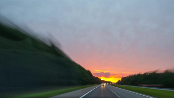 Riding along the road with sunset, rear view,  time-lapse