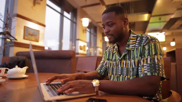 AfricanAmerican Man Win a Jackpot Looking in Laptop