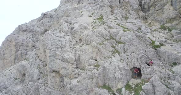 Aerial drone view of a cave and hiking in the mountains