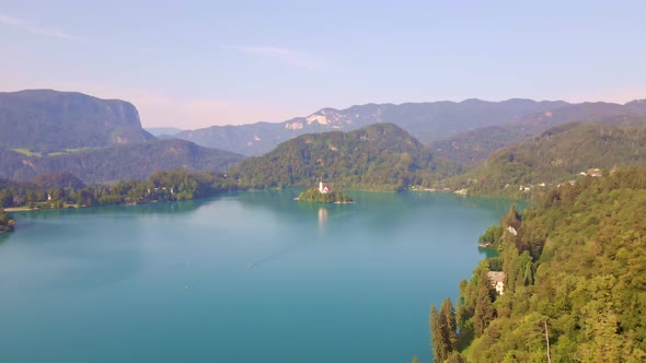 Aerial clip over Lake Bled Slovenia towards Bled Island a popular tourist destination in the Julian