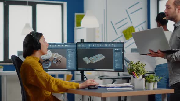 Industrial Designer Discussing with Woman Engineer Looking at Pc