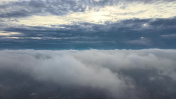 Aerial View From High Altitude of Earth Covered with Puffy Rainy Clouds Forming Before Rainstorm