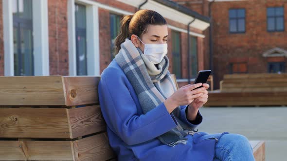 Woman in Face Mask with Smartphone in City