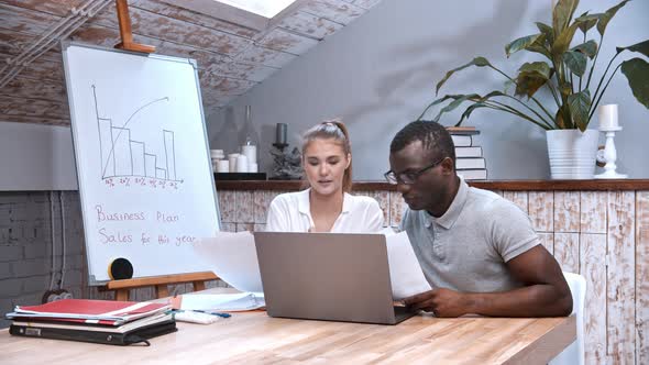 African-american Man and Caucasian Woman at the Business Meeting - Discussing the Plan and Holding