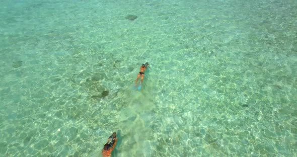 Aerial drone view of a man and woman couple snorkeling with seascooters