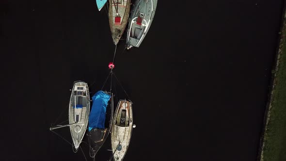 Low fly over sail boats parked on canal