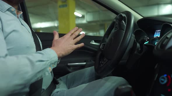 Man Driving in Innovative Automated Car Using Selfparking Autopilot for Parking on Parking Lot