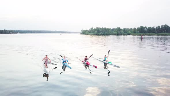 Well-coordinated Team Kayaking on Lake