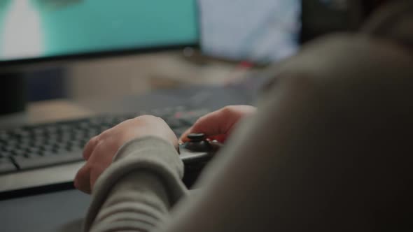 Close Up on Hands of Video Gamer Playing Using Wireless Joystic