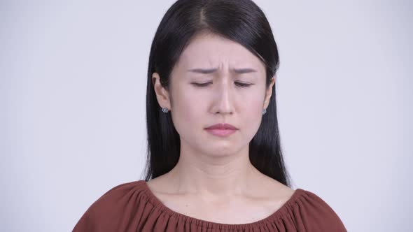 Face of Sad Asian Woman Looking Depressed and Crying