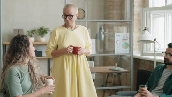 Group of Diverse Coworkers Talking on Coffee Break in Office