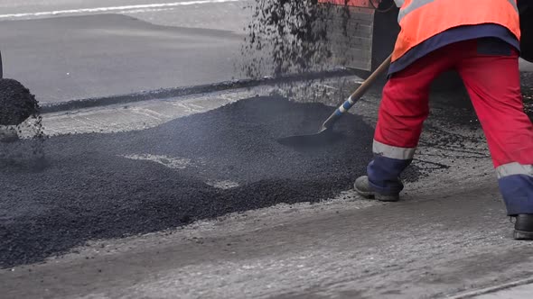 Bad Road. Roller and Workers on Asphalting and Repair of City Streets.