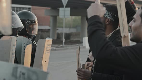 Protesters Chanting before Riot Police Officers