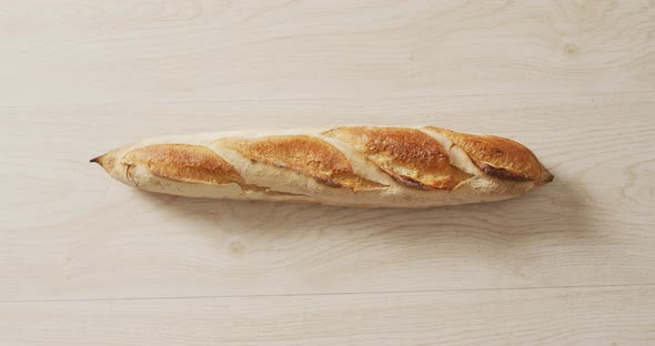 Video of close up of baguette on a black surface