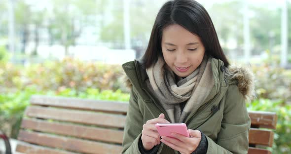 Woman using smart phone in the park