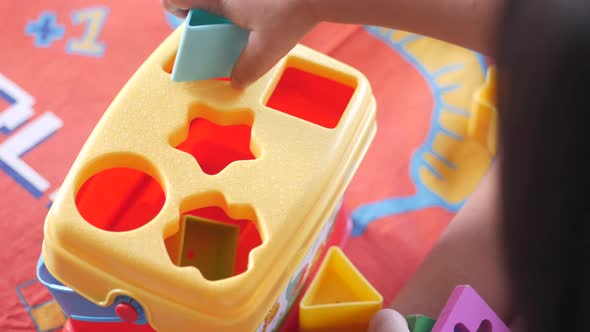 Child Playing with Geometric Shapes Toys