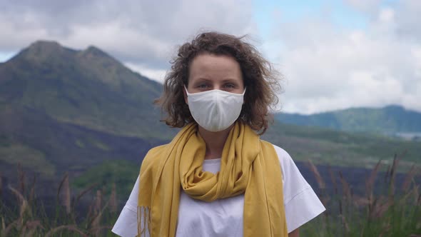 Portrait of a Caucasian Woman in a Face Mask Looking to the Camera