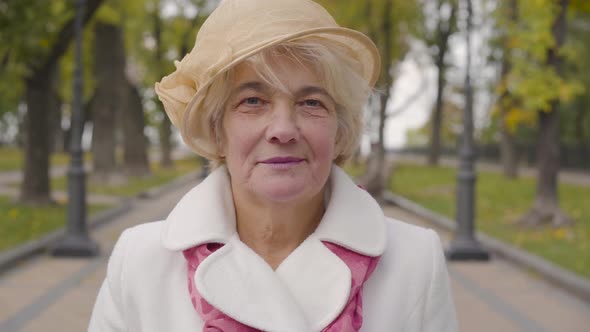 Close-up of Senior Caucasian Woman with Blue Eyes Looking at the Camera and Smiling