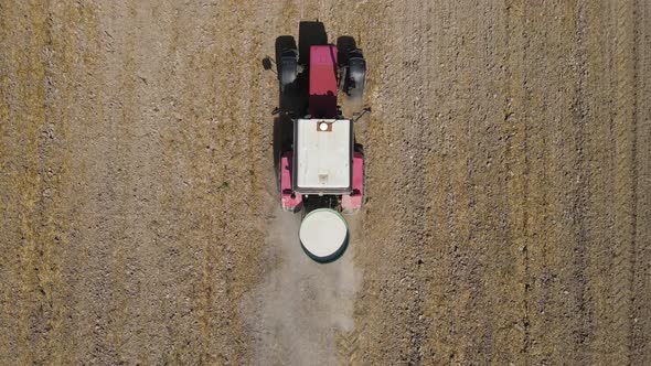 The Tractor Spreads Fertilizer To Improve The Harvest  