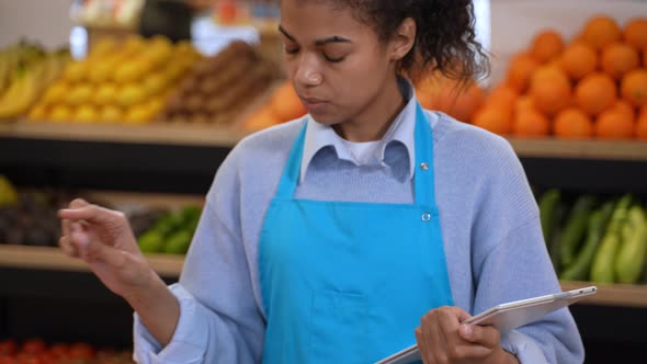 Farm Store Employee Taking Inventory of Groceries