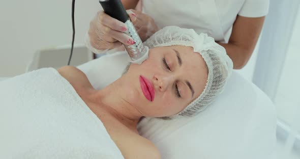 Woman Having a Stimulating Facial Treatment