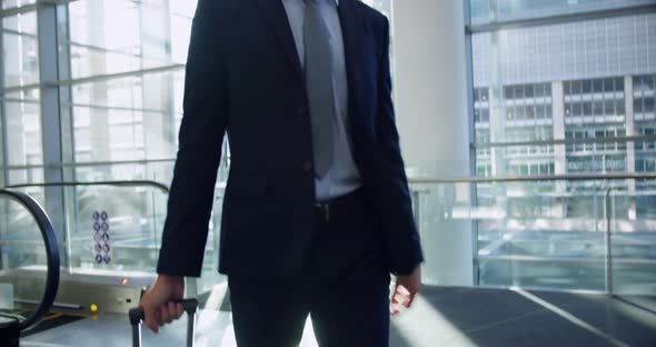 Businessman walking with luggage in the lobby at office 4k