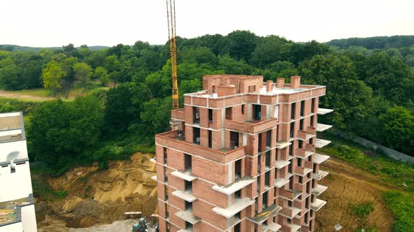 Aerial Flight Near the Construction of a Multistorey Building in a Forest Area