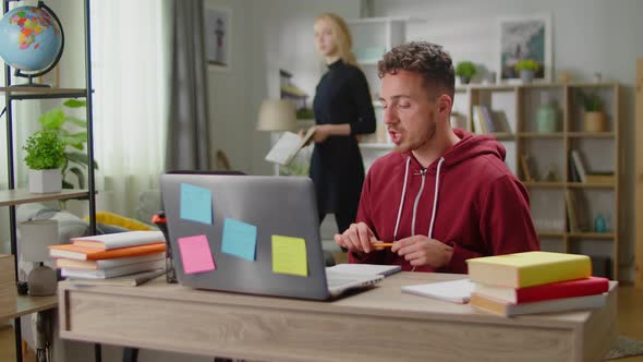 Young Tutor Woman Teaching Young Man at Home in Living Room