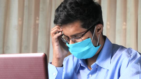 Businessman in Face Mask Working on Laptop 