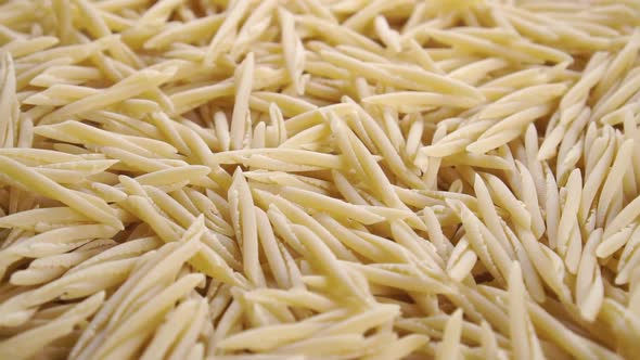 Italian uncooked dry trofie pasta. Rotation. Close up