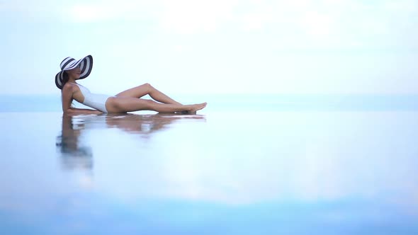 Young asian woman enjoy around outdoor swimming pool for leisure