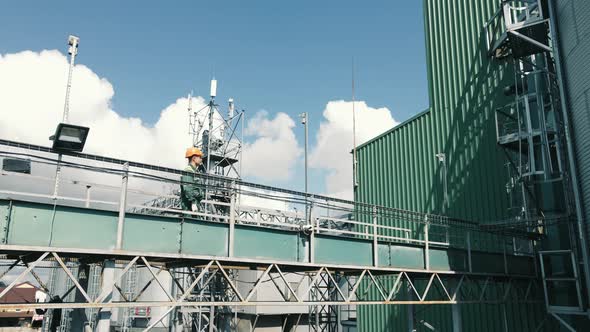 The Production Engineer Goes Over the Metal Structures and Inspects the Plant