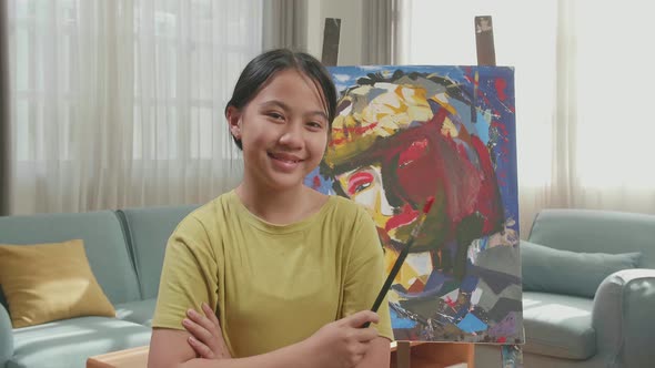 Asian Artist Girl Holding Paintbrush Crossing His Arm And Smiling