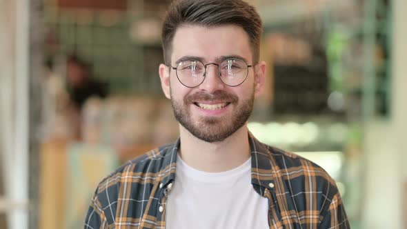 Portrait of Happy Young Man Smiling at Camera