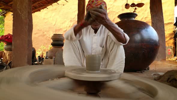 Potter at Work Makes Ceramic Dishes