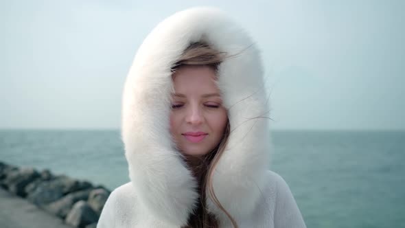 Woman Stands Against Lake Garda with Waves in Windy Weather