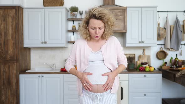 Pregnant Woman Suffering From Stomachache At Home
