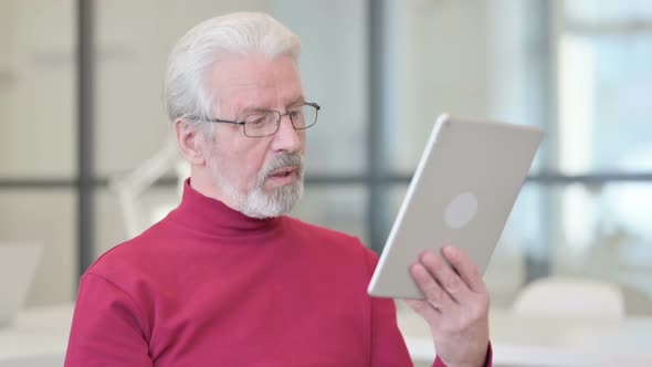 Video Call on Tablet By Old Man