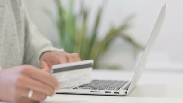 Close Up of Hands of African Woman Making Online Payment on Laptop