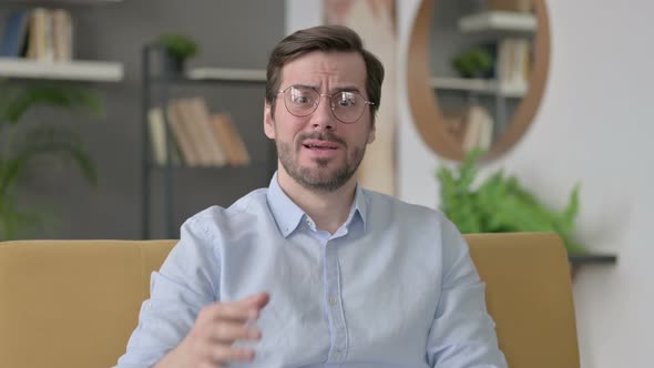 Portrait of Young Man Getting Angry on Video Call