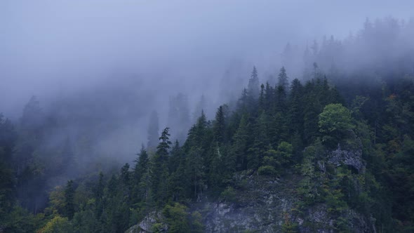 Fog moving above misty mountains