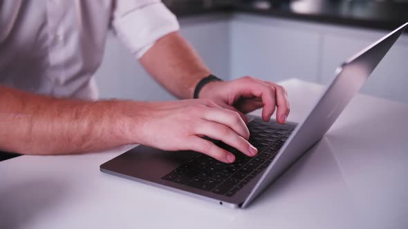 footage of man typing on laptop